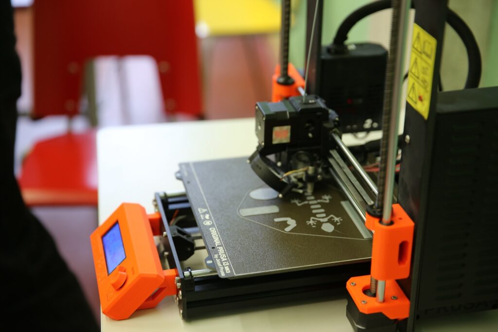 There is a Prusa mk3s 3D printer on the picture.