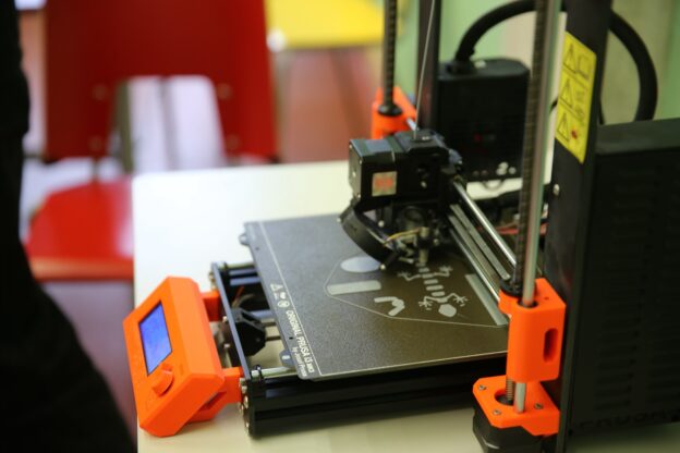 There is a Prusa mk3s 3D printer on the picture.